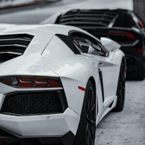 cars, super cars, luxury cars, lamborghini, corvette, black car, white car, sports cars, exotic cars, daytime, parked cars, car row, black lamborghini, white lamborghini, black corvette, high-end vehicles, automobile, car collection, outdoor